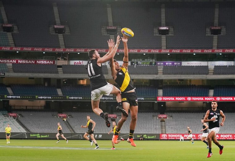 Players contesting the ball under stadium lights