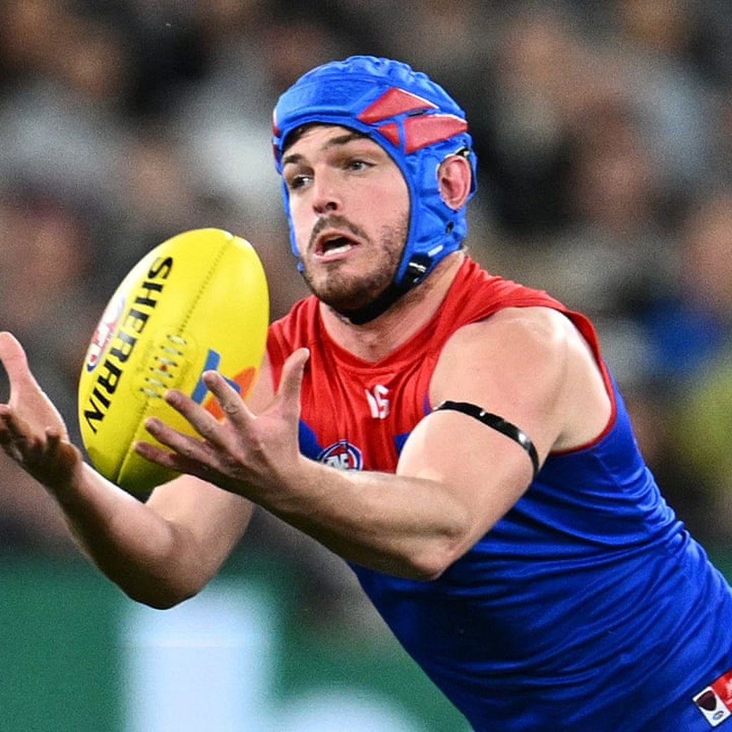 An AFL player catching the Sherrin ball during a match